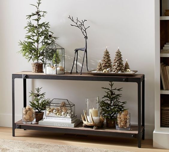Terrariums with faux snow and ornaments, evergreen trees in baskets and tree shaped candles look quirky