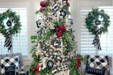 a Christmas tree decorated with buffalo check stars, buffalo check pillows, artworks and ribbons for a stylish vintage look