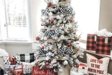 a farmhouse Christmas tree with mesh and buffalo check ribbons, white and red ornaments, branches and elegant pillows