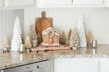 farmhouse Christmas decor with Christmas trees, a gingerbread house, and some cranberries