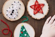 stylish Christmassy string art pieces made of tree slices and colorful yarn are amazing for woodland or rustic holiday decor