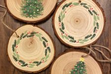 tree slice Christmas ornaments with painted trees and wreaths are amazing for bringing a rustic feel to the tree