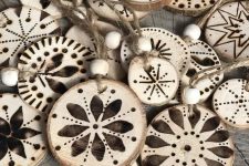 wood burnt tree slice Christmas ornaments with wooden beads and twine are great for styling a rustic Christmas tree