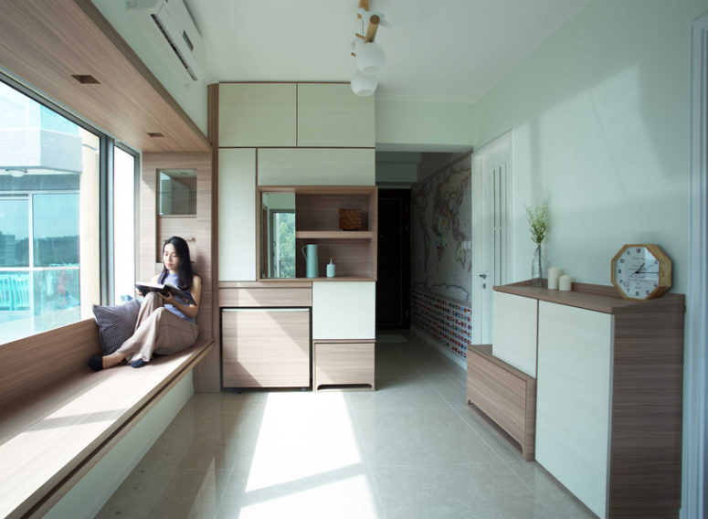 This minimalist apartment in Hong Kong is very functional and is built around bay windows