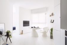 01 This small all-white apartment is done in minimalist style and features everything necessary for the owners