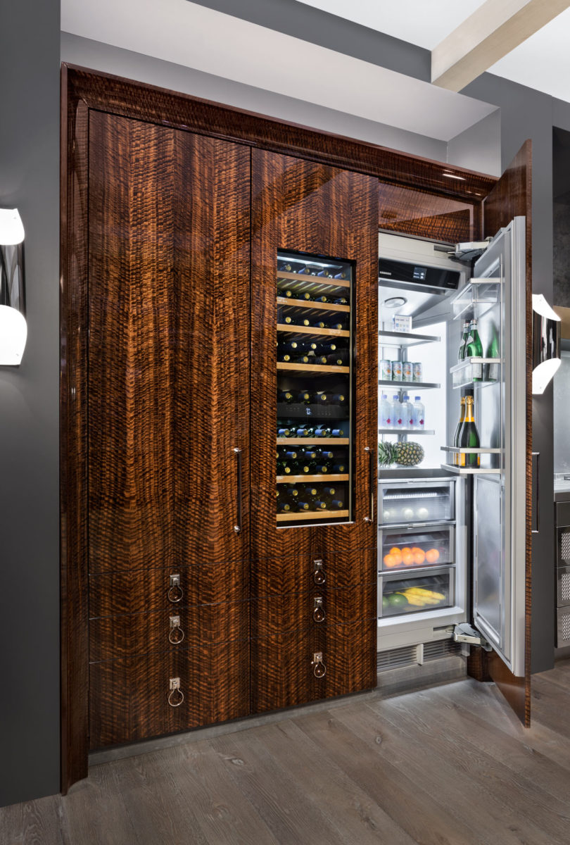 The fridges and wine freezers are fully covered with figured fumed eucalyptus