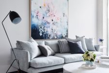 02 a bold oversized artwork over the sofa is a cool colorful statement