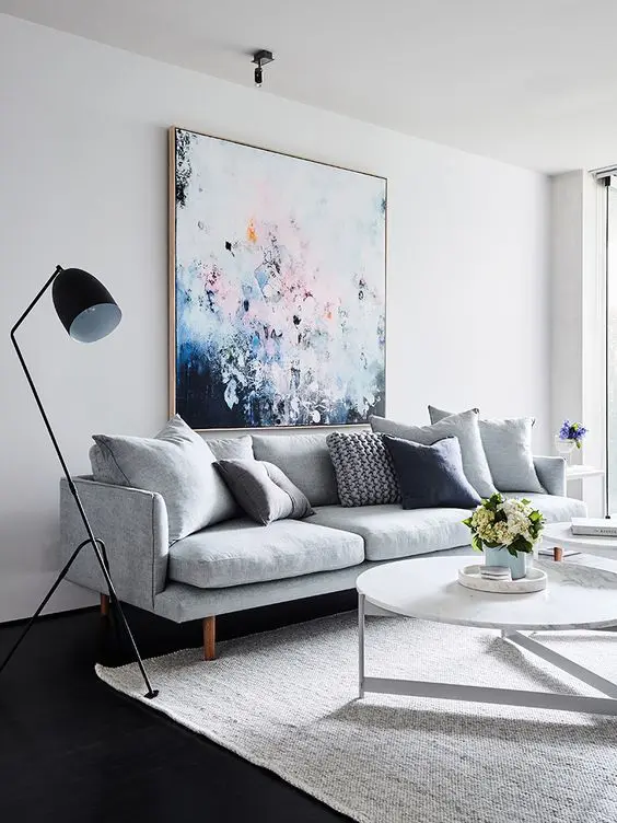 a bold oversized artwork over the sofa is a cool colorful statement
