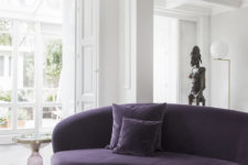 03 Floor to ceiling windows make the space feel airy, and the deep purple sofa makes a colorful accent