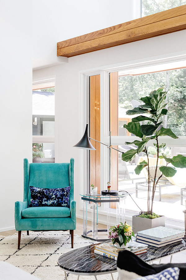 Potted plants and such touches like this turquoise chair enliven the space