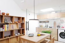 03 The kitchen is attic, with much light-colored plywood in decor, and there’s a cozy dining space next to it
