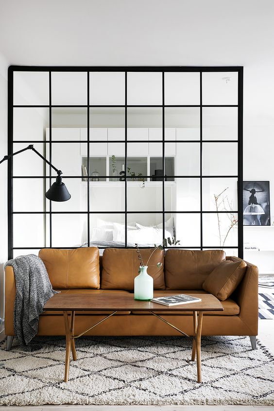 A Stockholm sofa in tan leather looks ideal in a light filled Scandinavian space