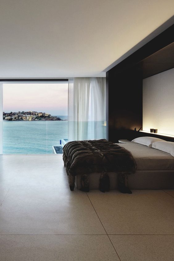 A spacious masculine bedroom with a gorgeous sea view