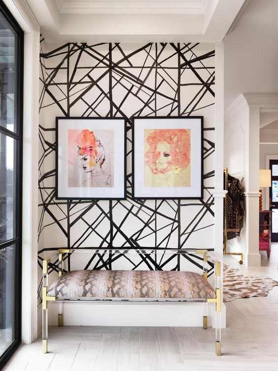 an entryway with a black and white geometric wall as a bold accent