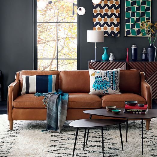 A Stockholm sofa in tan leather adds texture and comfort to this eye catchy space