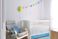 05 IKEA Stuva cot with bold blue drawers for a colorful nursery