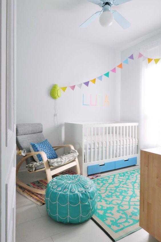 IKEA Stuva cot with bold blue drawers for a colorful nursery