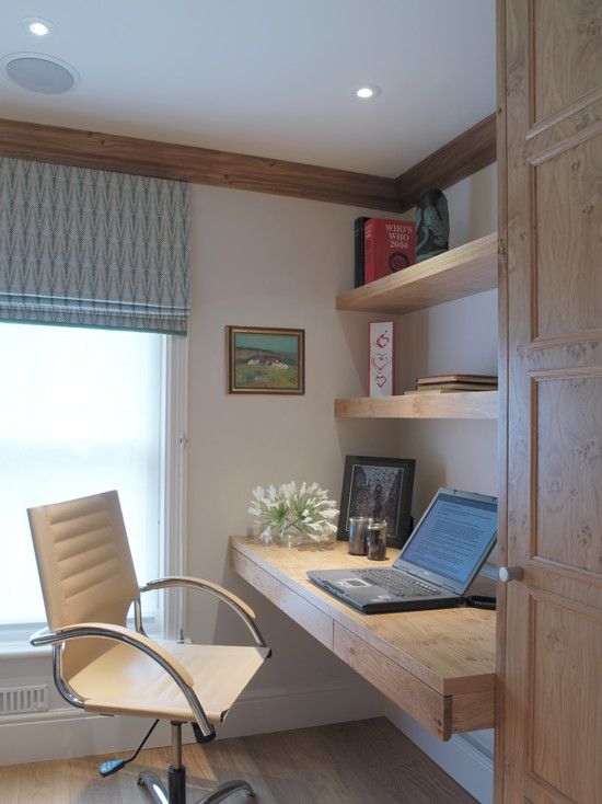a small yet comfy working nook with floating shelves and a desk with drawers made of light-colored wood