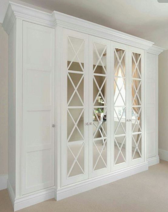 classic mirrored doors with criss cross frames make the wardrobes stand out