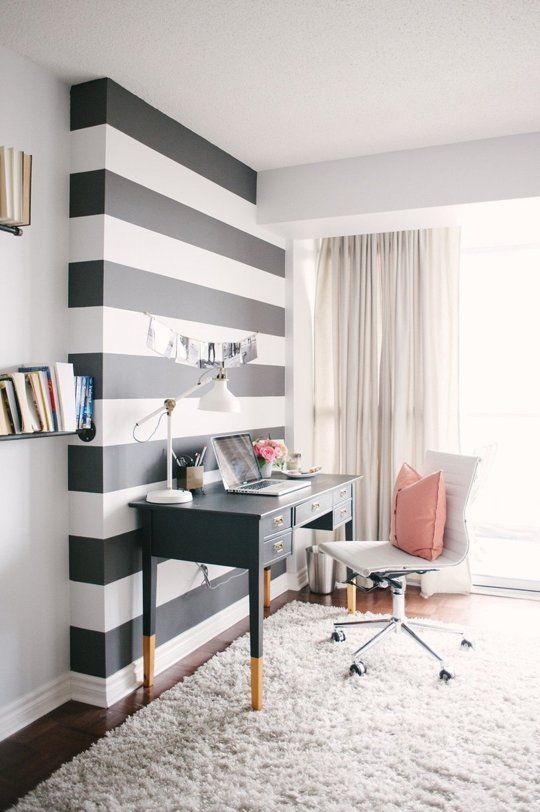 the home office accentuated with a black and white striped wall