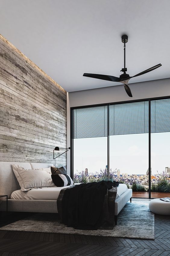 This rustic masculine space features a glazed wall with views of the city