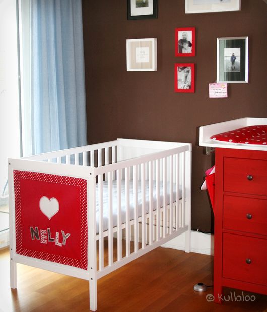 IKEA Sundvik cot with a colorful fabric accent with the baby's name