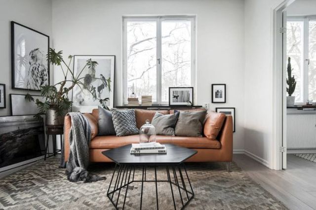 a Scandinavian apartment in grey, black and white with a tan leather Stockholm sofa for a warm touch