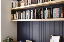 06 a black wall and light-colored wooden floating shelves plus a desk below for reading and studying