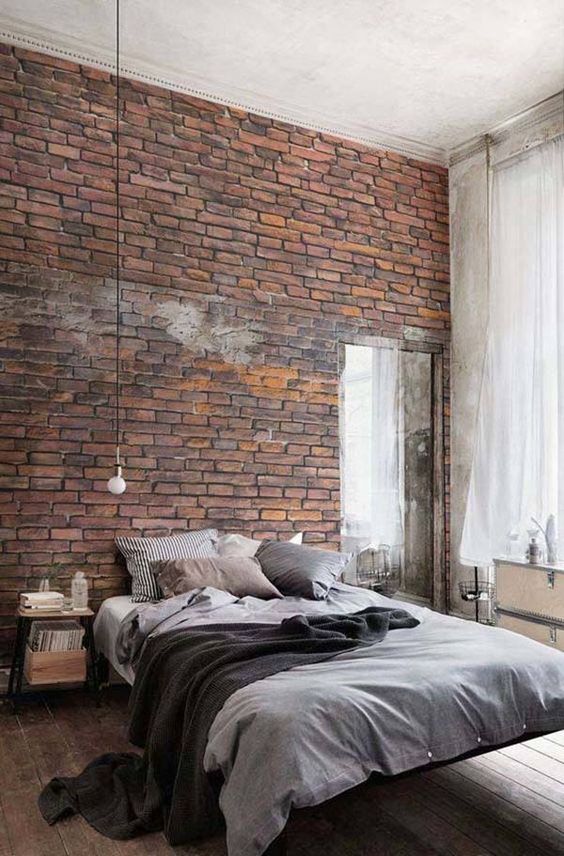 an exposed brik wall is a great idea for a masculine bedroom or an industrial space