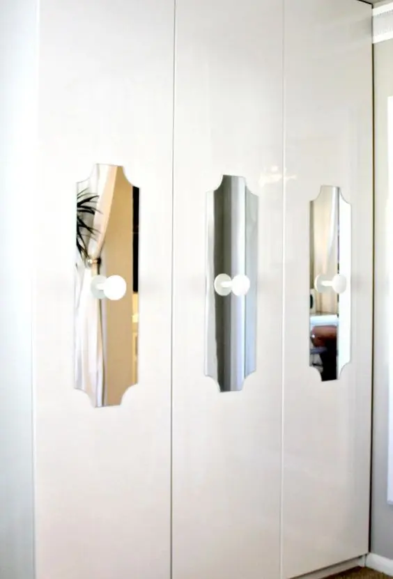 cutout mirror touches with white knobs add interest to a Pax wardrobe