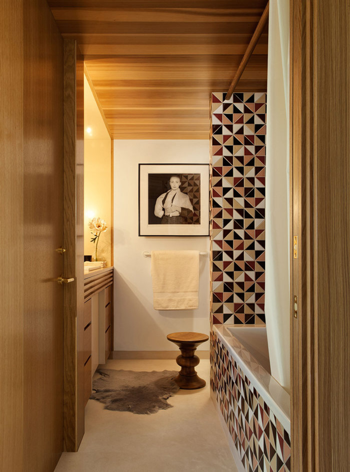 The second bathroom features mosaic geometric tiles in the bathtub zone, and some wood