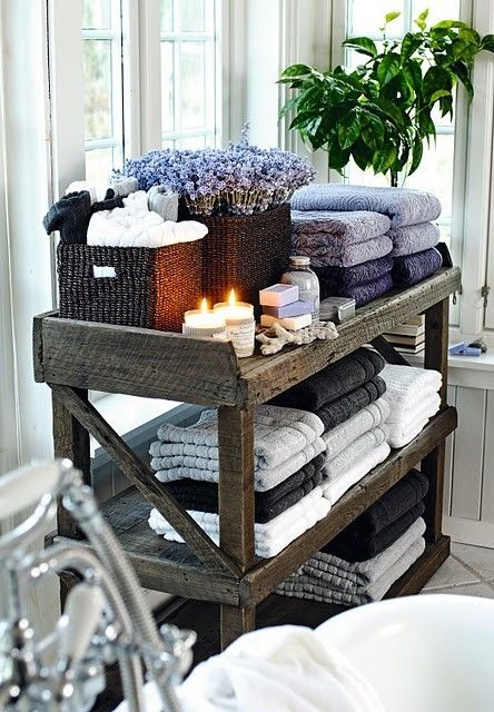 add a wooden stand with towels, candles, soaps and flowers for a stylish feel