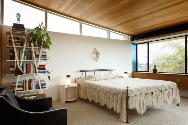 The bedroom is done with some skylights, an eye-catchy bookshelf and some more stylish mid-century furniture