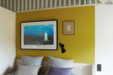 09 The guest bedroom is colorful, with a bold wall and bedding plus comfy furniture