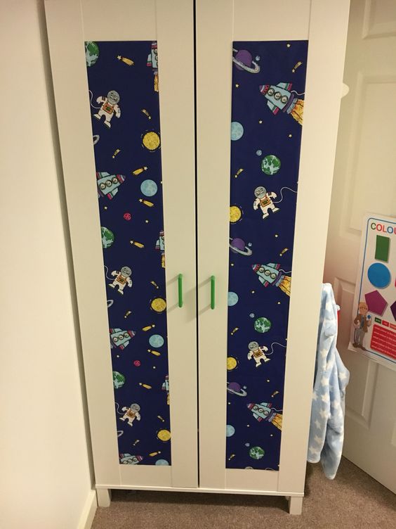 a fun Aneboda hack with bold green handles and spaceman printed wallpaper for a boy's room
