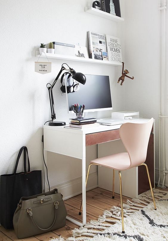 a girlish workspace with a Micke desk with a dusty pink drawer and a matching chair with brass legs