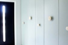 12 IKEA Pax wardrobes in a mint shade with creative round handles at different heights