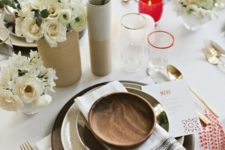 12 simple table decor with black chargers, neutral florals and red candle holders