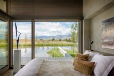 13 The master bedroom shows off a comfortable bed, a cool sculpture and amazing views