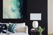 13 a bold statement artwork on a black wall is a chic idea and black will highlight it
