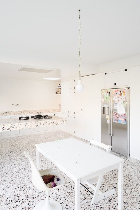 a terrazzo floor, countertops and a floating kitchen island for a trendy look