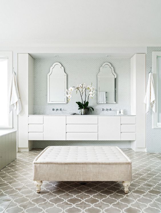 an oversized neutral upholstered ottoman as a comfy seating in your bathroom