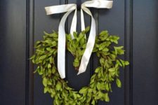 14 a boxwood heart wreath with a ribbon bow to decorate the front door