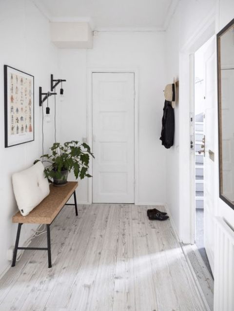 a minimal entryway with a metal and cork bench that is perfectly cozy and comfy