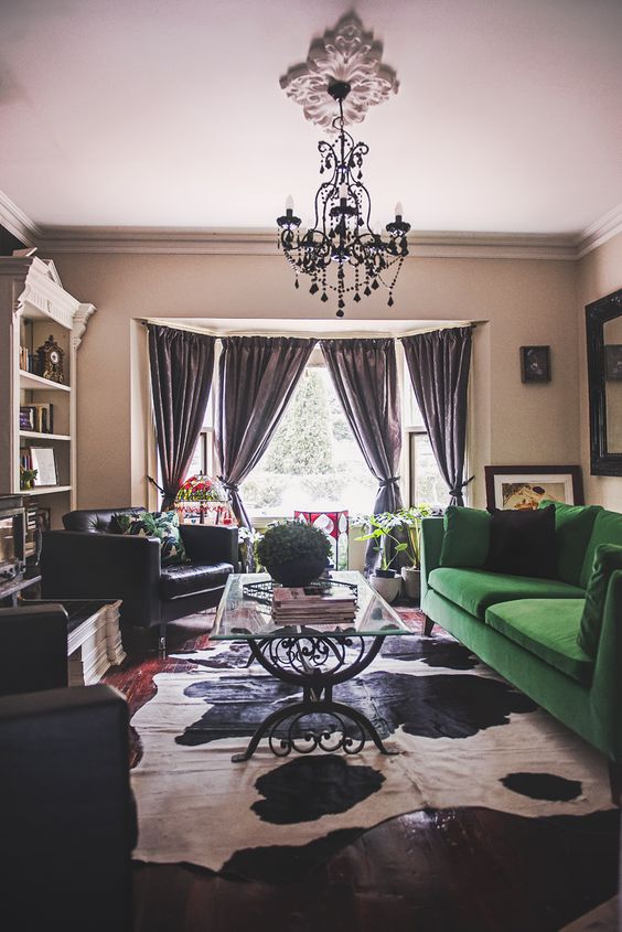 A moody living space with a bold splash   an emerald green Stockholm sofa that makes a statement