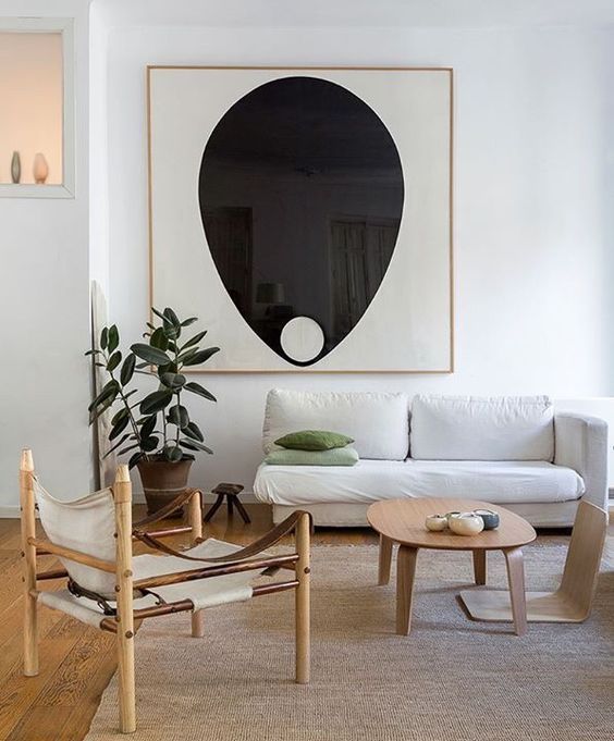 an abstract statement artwork is the focal point in this neutral space