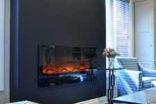 15 a black accent wall with a built-in fireplace for a cozier feel