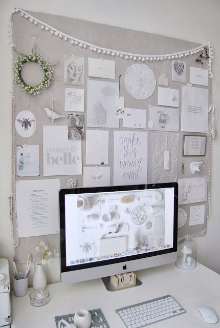 a large pinboard covered with light grey fabric for a light shabby chic or vintage feel