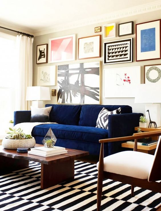 a navy Stockholm sofa makes a colorful statement in this monochromatic space