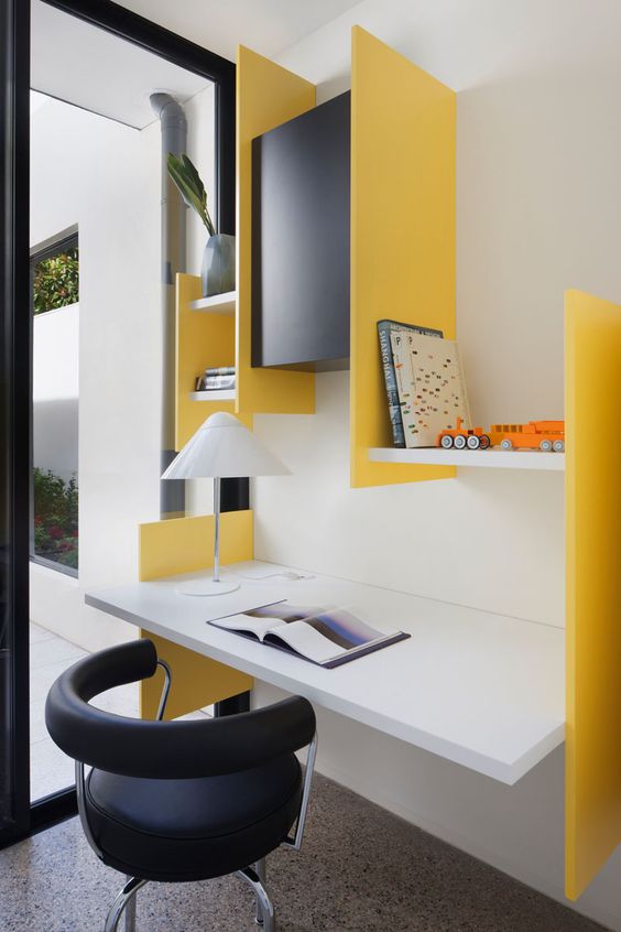 a colorful modern workspace with a floating desk and some colorful geometric shelves